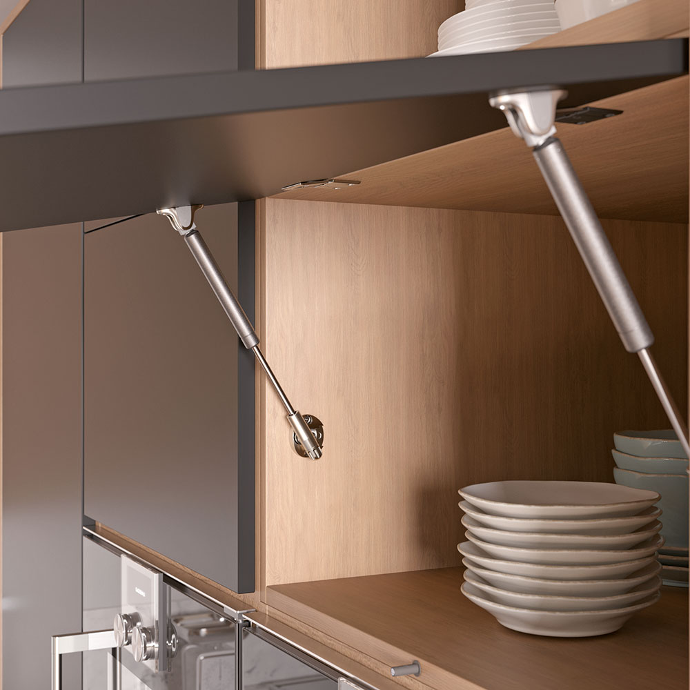 Close-up of a Kraby lift-up gas spring in a cabinet with a stack of plates
